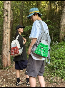 Outdoor leisure backpacks in forest setting with drawstring mesh pockets and color contrast