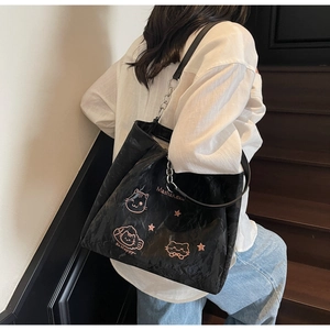 Nahaufnahme schwarzer Shopper mit rosa Katzenmuster und silbernem Metallkettenriemen