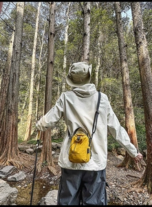 Outdoor yellow drawstring bucket bag with water-repellent fabric and adjustable strap