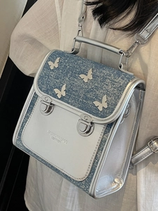 Chic silver and blue denim backpack for women featuring 3D butterfly decor and metallic buckles