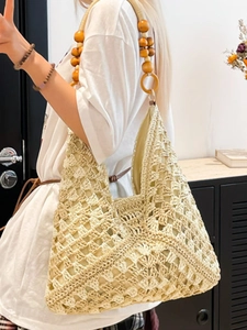 Large beige woven crochet tote bag with hollow diamond patterns and wooden bead straps