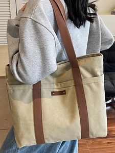 Large capacity khaki canvas tote bag with brown straps for commuting and daily use