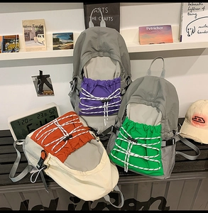 Detailed view of three lightweight outdoor backpacks with bungee cords and mesh pockets