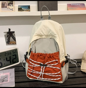 Detail view of water-resistant nylon backpack with contrast color and elastic drawstring