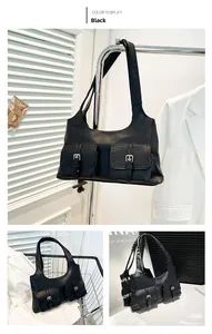 Detail view of black underarm bag with double utility pockets and silver metal buckles
