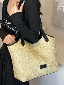 Large straw tote bag with black leather handles and fashion logo for beach vacation