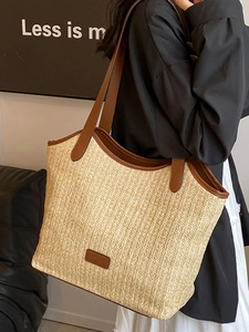 Chic woven straw tote bag with brown leather handles for summer beach vacations