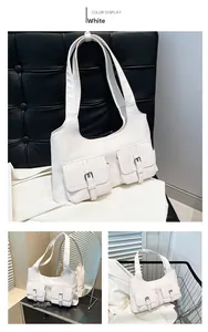 Detail view of white PU leather underarm bag featuring dual front buckle pockets