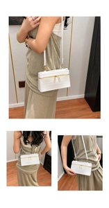 Detailed views of a white crocodile pattern box bag with golden zipper and slim shoulder strap