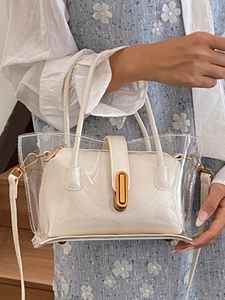 Transparent PVC tote bag with white leather inner pouch and gold hardware handles