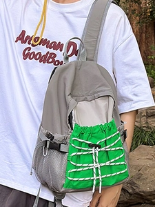 Lightweight grey outdoor backpack with neon green drawstring pocket for hiking and travel