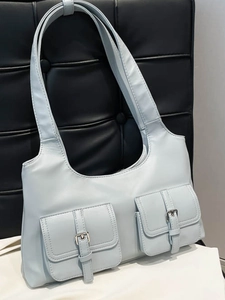Minimalist light blue underarm bag with double front pockets and silver buckles