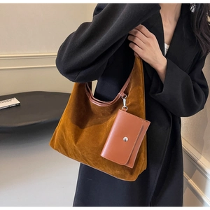 Detail view of large brown suede hobo tote with a detachable mini pouch and silver hardware