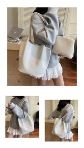 Detail of white crocodile pattern tote bag with matching zipper pouch and shoulder straps