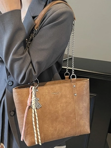 Minimalist brown leather tote bag with silver chain strap for women office commute style