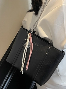 Minimalist black leather tote bag with silver studs and chain strap for women