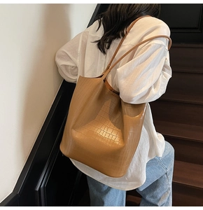 Close-up of minimalist camel brown tote bag with premium crocodile embossed texture