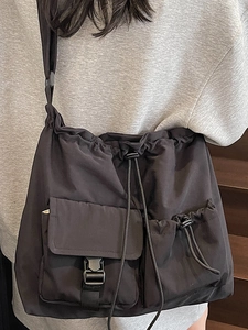 Large capacity black nylon drawstring shoulder bag for travel with utility pockets
