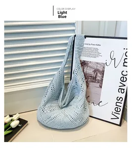 Detail of light blue hollow crochet tote bag with geometric pattern in bohemian style