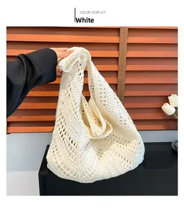 Close-up of white crochet shoulder bag showing intricate hollow diamond knit patterns