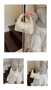 Detail view of white quilted shoulder bag with silver star emblem and metal rivets