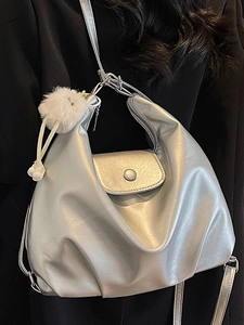 Silver metallic pleated tote bag for women with white plush monster charm accessory