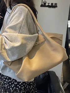 Minimalist beige leather tote bag with stylish buckle strap and large capacity for women