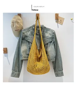 Detail view of yellow hollow crochet woven shoulder bag with wide strap craftsmanship