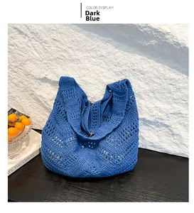 Detail of deep blue hollow knit crochet tote bag with bohemian diamond pattern textures