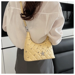 Quilted diamond pattern shoulder bag with crystal star detail worn by model
