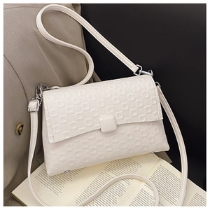 Detail of white rectangle crossbody bag showing small square embossed texture and leather buckle