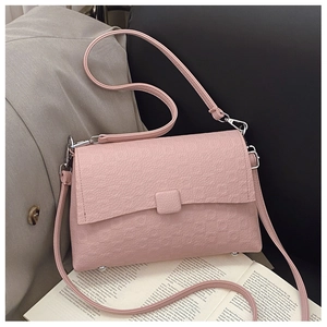 Close-up of pink litchi texture leather handbag with square buckle and silver metal hooks