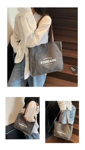 Close-up of canvas tote bag with front pocket and contrast PU leather handles