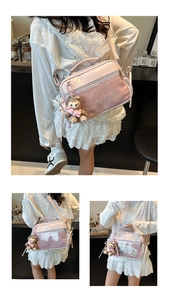 Detail view of pink PVC jelly bag showing the transparent window and plush bear charm
