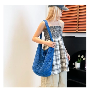 Detailed close-up showing the hollow crochet texture of the blue bohemian woven tote bag