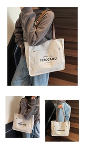 Three-way view of a large canvas tote bag with brown leather straps and printed text