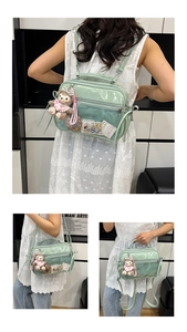 Detail view of a light green ITA bag featuring a clear display window and plush bear charm