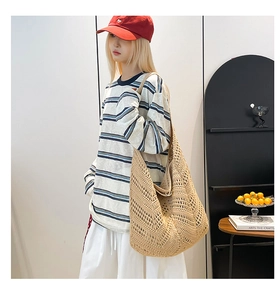 Detail of bohemian beige hollow crochet tote bag with artisanal woven pattern design