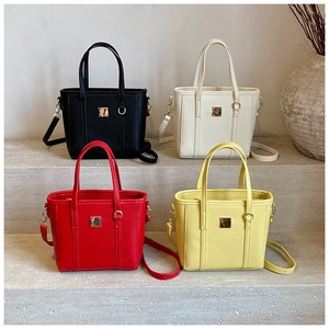 Litchi pattern bucket bags in black, white, red, and yellow with golden metal plates