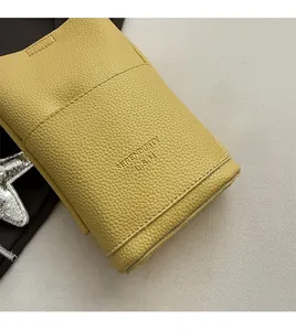 Detailed macro view of the light yellow lychee pattern leather and embossed logo