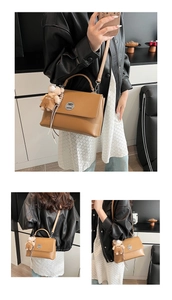 Detail view of brown leather crossbody bag with silver hardware and bear charm