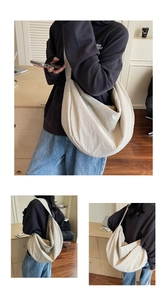 Detailed close-up showing the soft woven nylon texture of this cream crescent tote bag