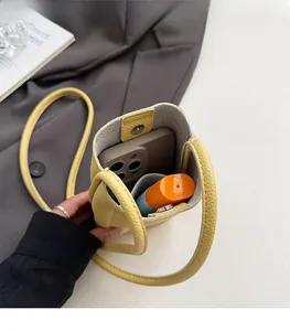 Detail view of ginger yellow lychee leather phone bag with magnetic buckle and spacious interior