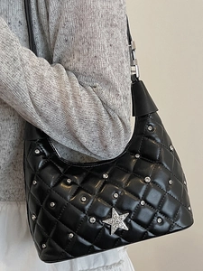 Quilted black hobo bag with silver studs and a rhinestone star on shoulder