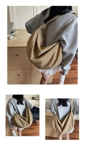 Detailed view of khaki moon bag with wash texture fabric and side zipper pocket