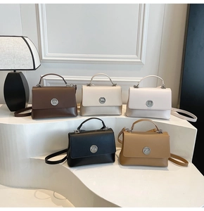 Five structured tote bags in black, brown, cream, and beige colors on a tiered display