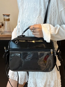Glossy black PVC shoulder bag with clear display window and adjustable strap for women