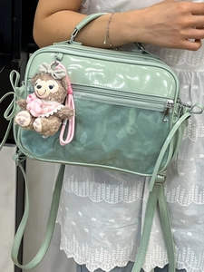 Mint green PVC crossbody ita bag with clear window and plush toy accessory