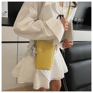 Detailed view of yellow lychee texture leather crossbody bag with star pendant