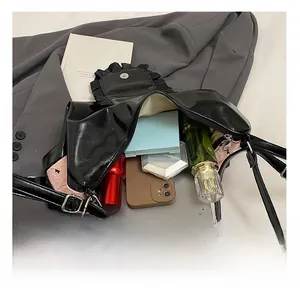 Interior view of black patent leather tote bag showing large capacity for tablet and cosmetics